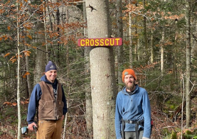 Two workers posing with a new trail sign
