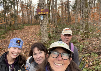 A group of volunteers posing on the side of a trail